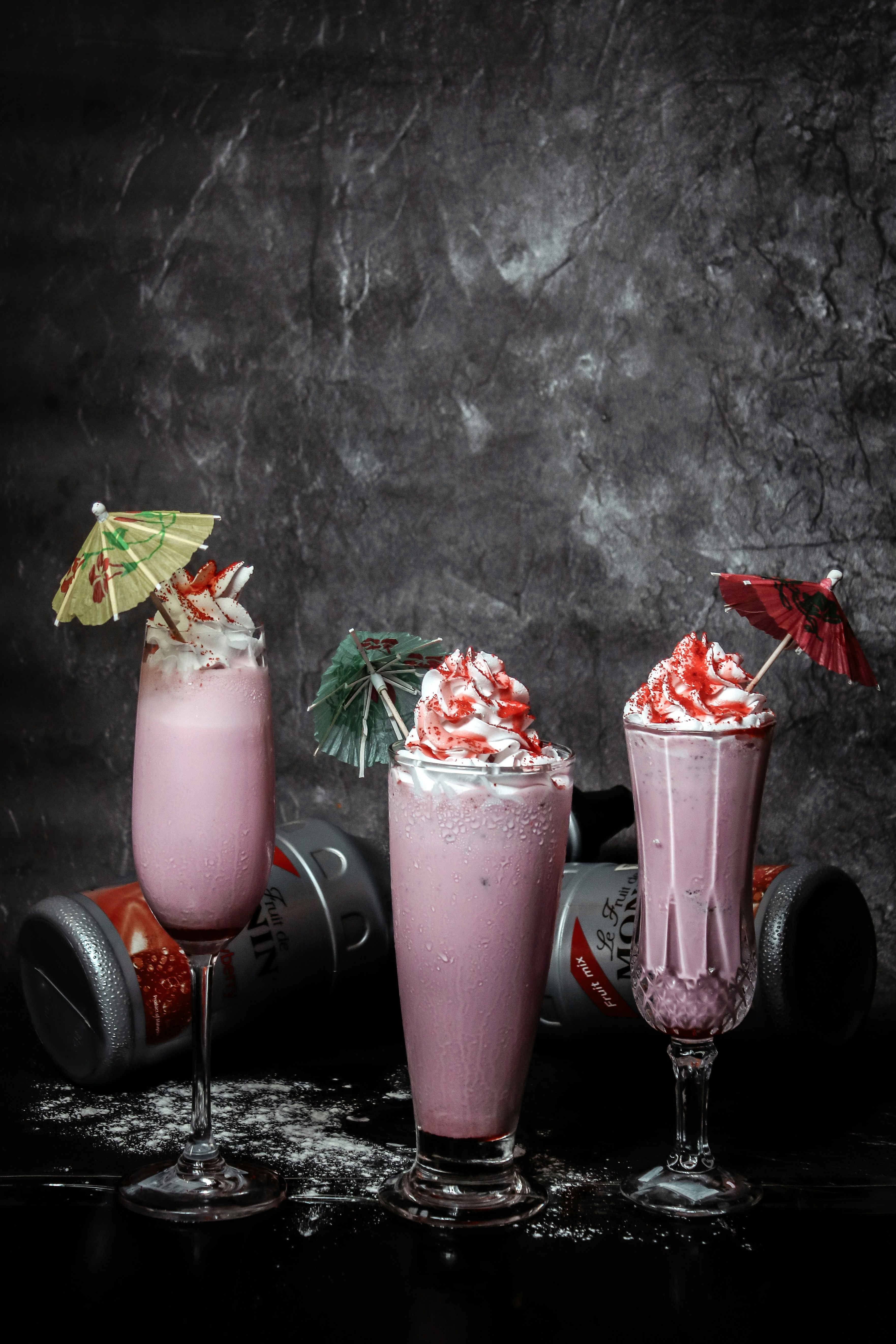 three drinks with umbrellas on top of them