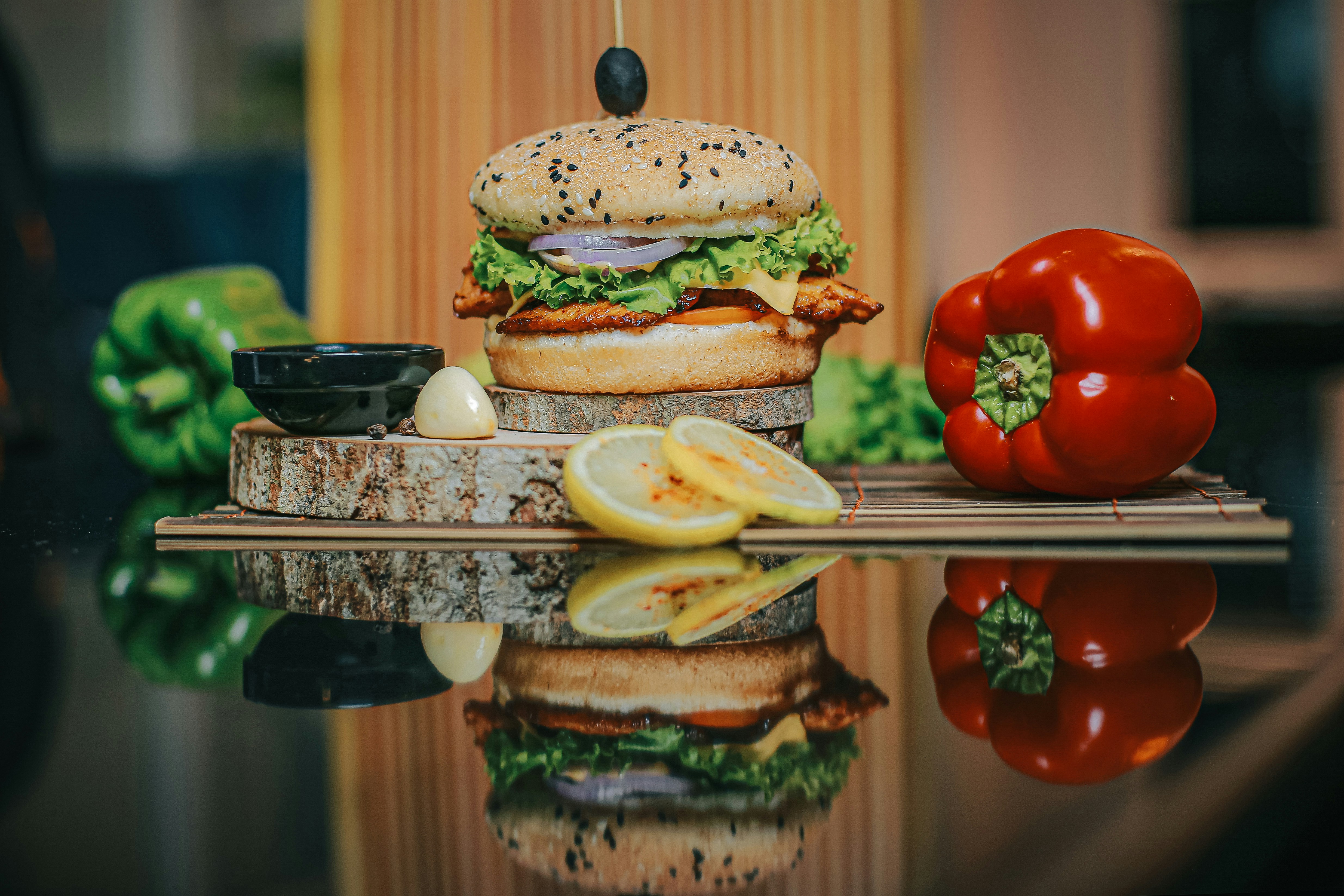 Delicious gourmet burger with lettuce, cheese, grilled chicken and onions