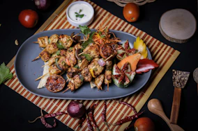 a blue plate topped with meat and vegetables
