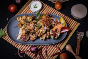 a blue plate topped with meat and vegetables