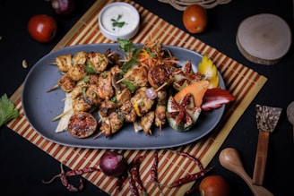 a blue plate topped with meat and vegetables