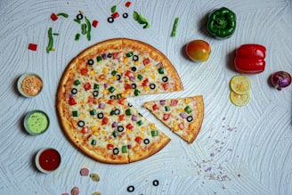 a pizza sitting on top of a table covered in toppings