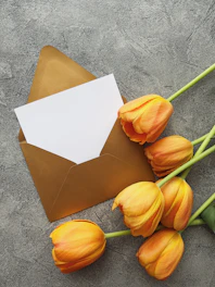 a bunch of tulips sitting next to an envelope