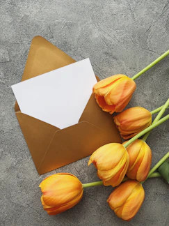 a bunch of tulips sitting next to an envelope