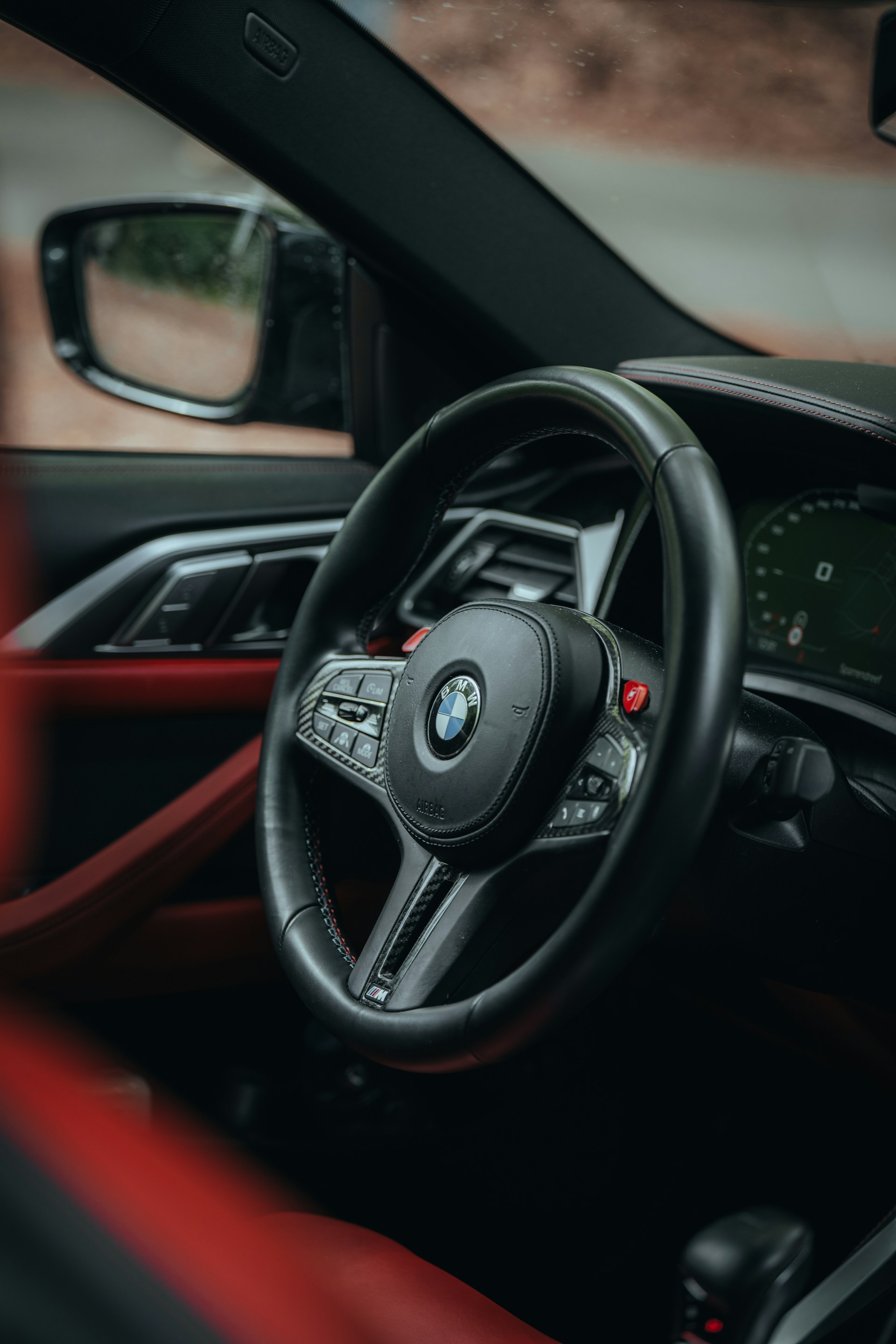 the interior of a car with a steering wheel and dashboard