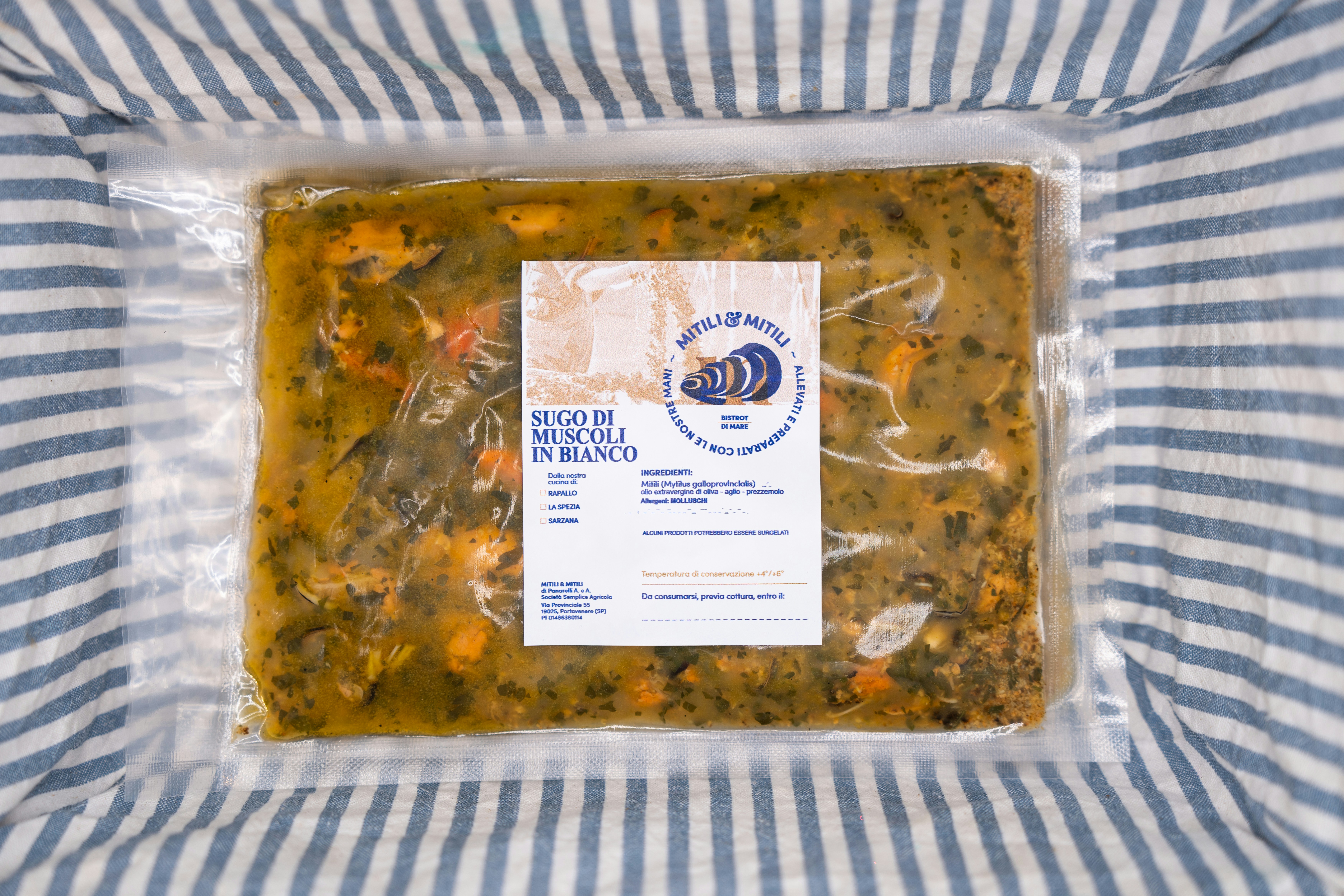 Frozen soup in clear plastic container with product label on striped background