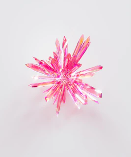 a close up of a pink object on a white surface
