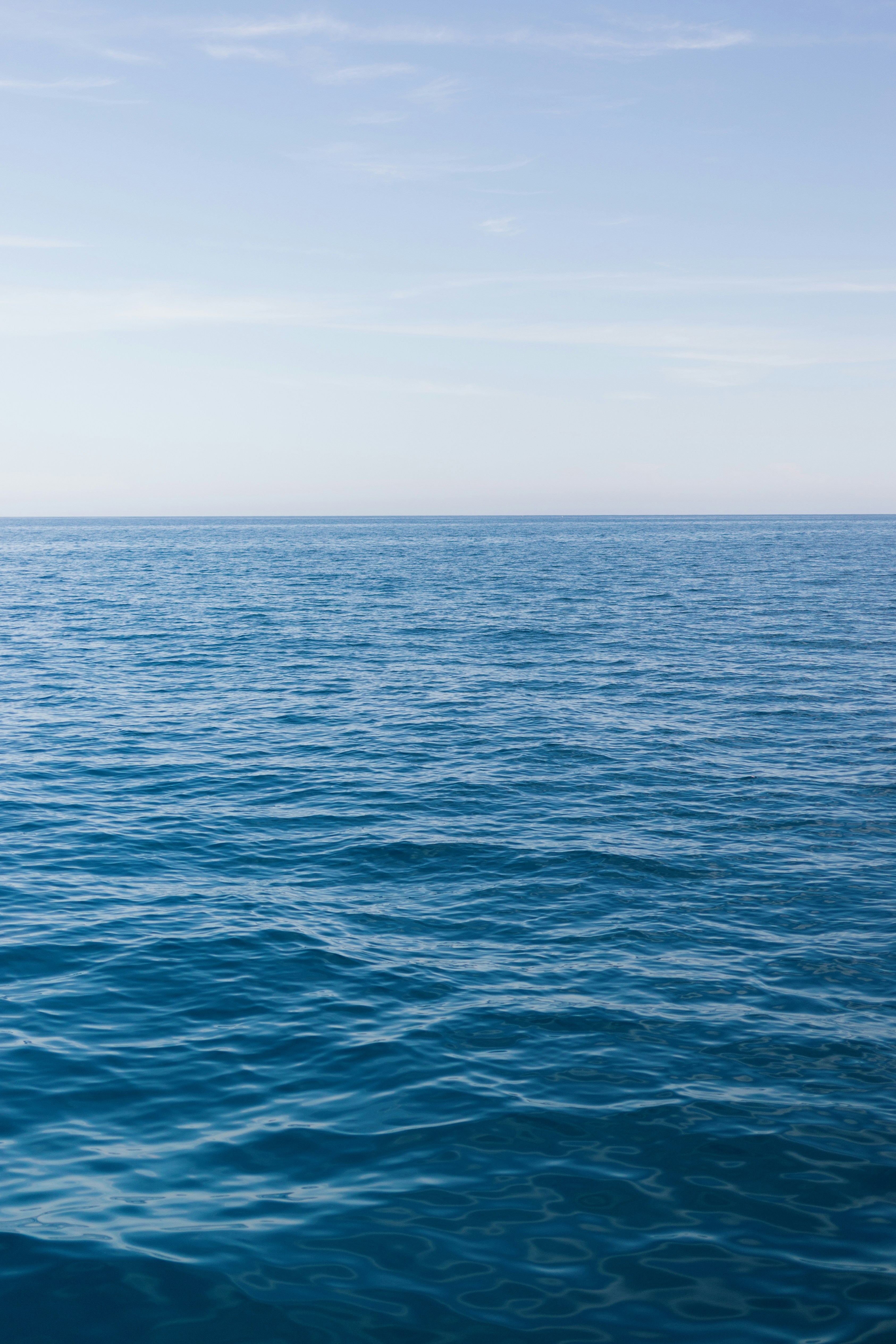 a large body of water with a boat in the distance