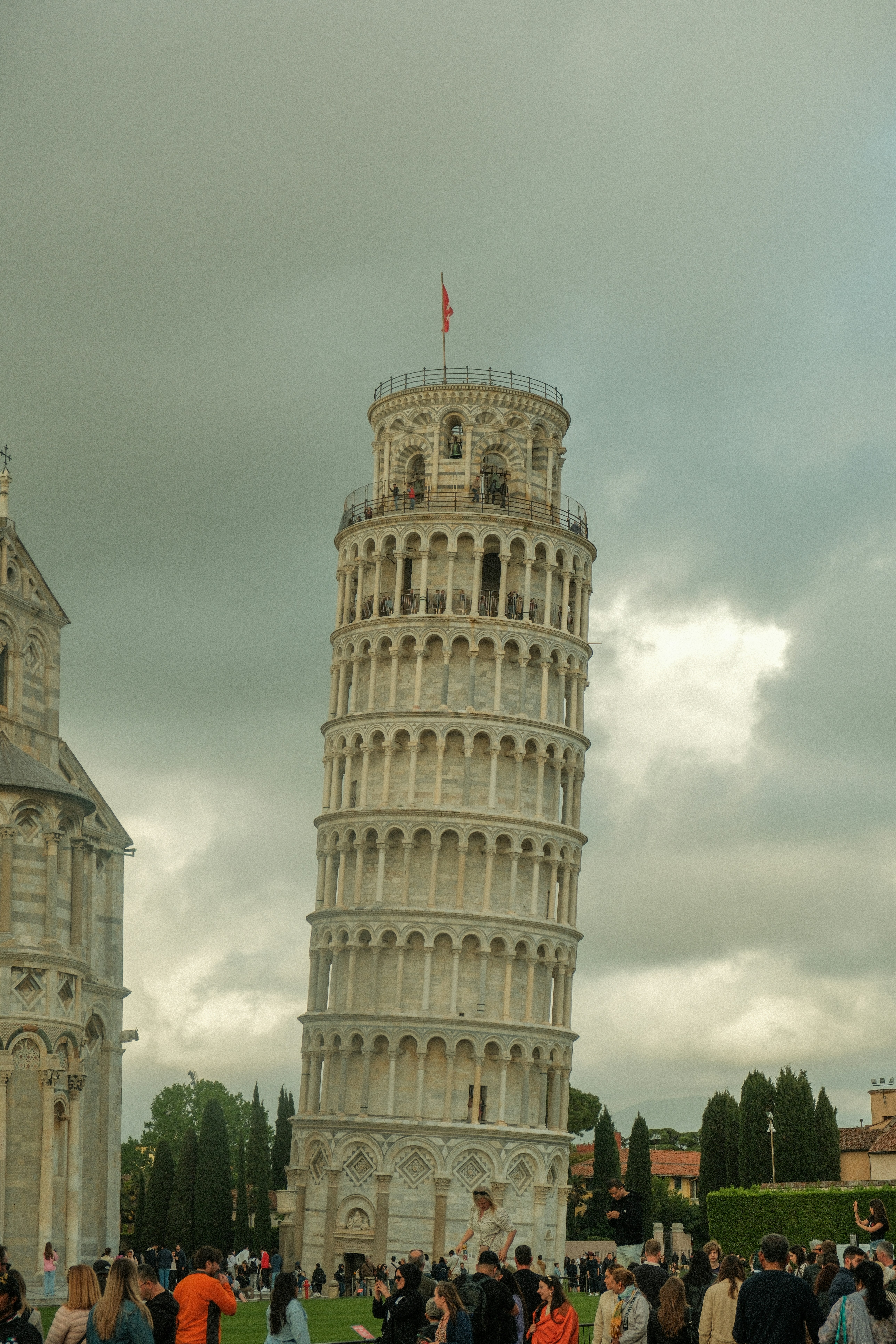 a group of people standing in front of a tall tower