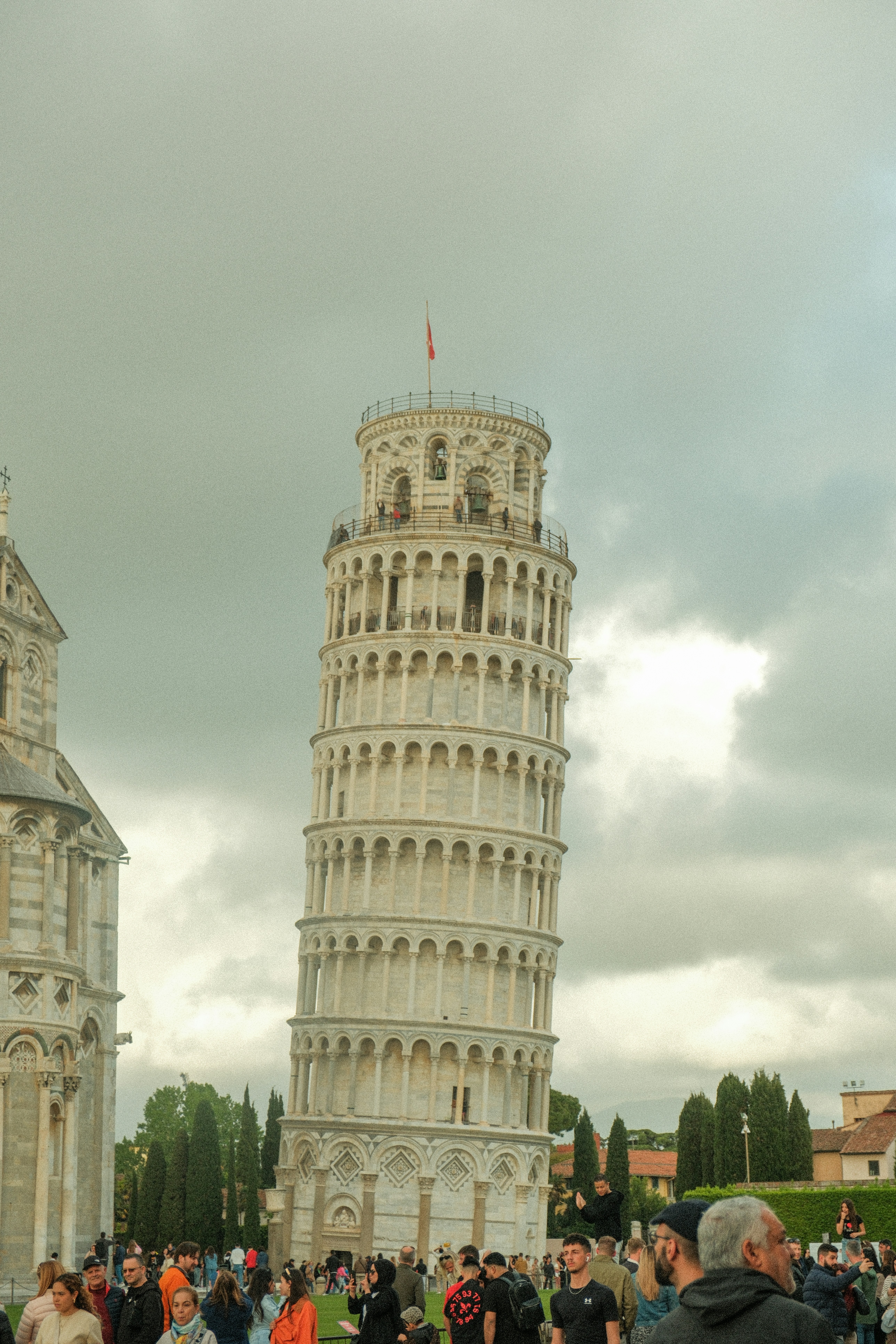 a group of people standing in front of a tall tower