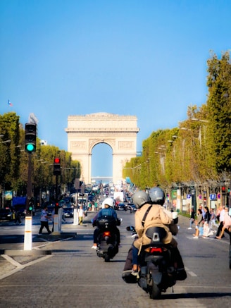 a group of people riding motorcycles down a street