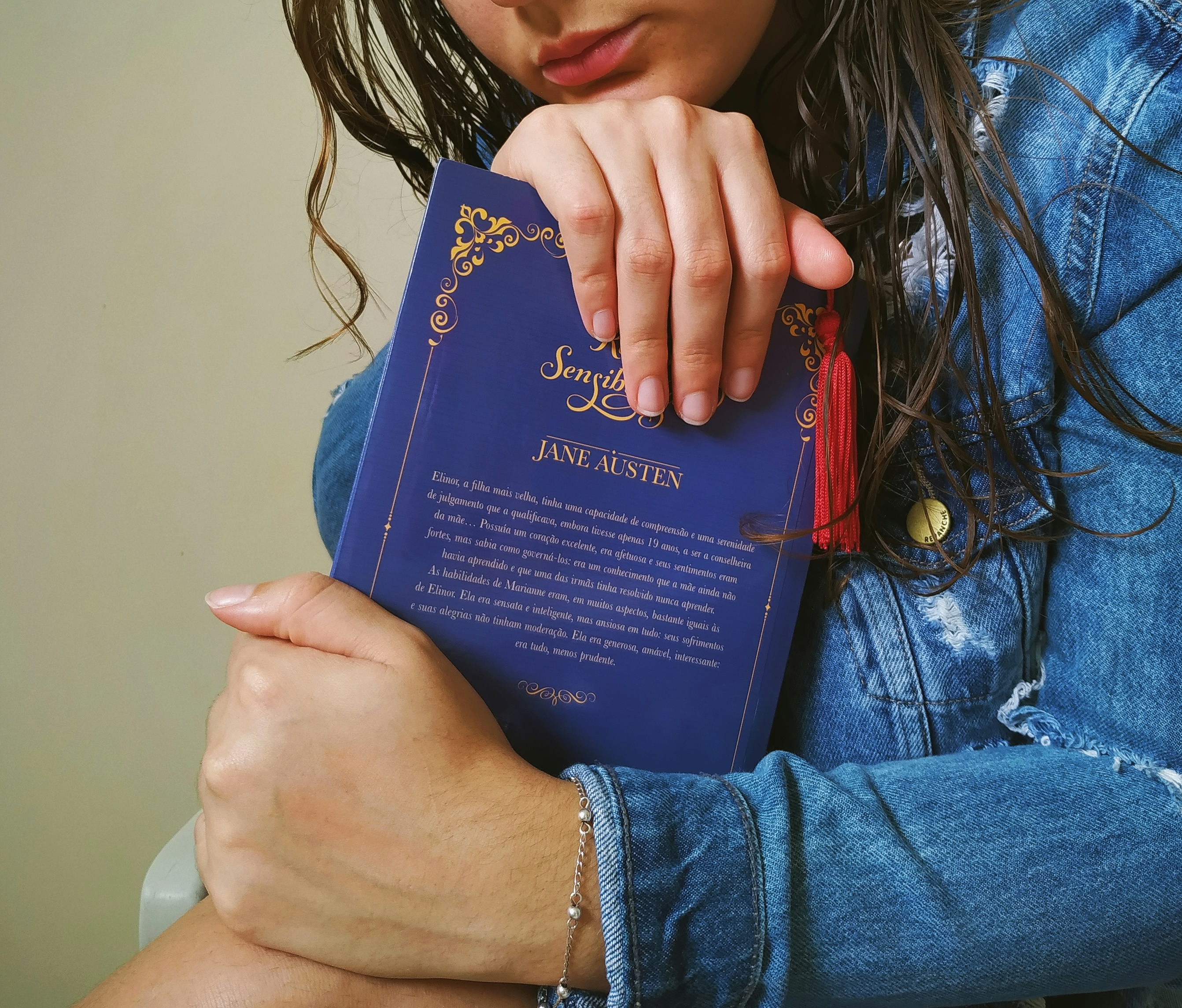 a woman holding a blue book in her arms