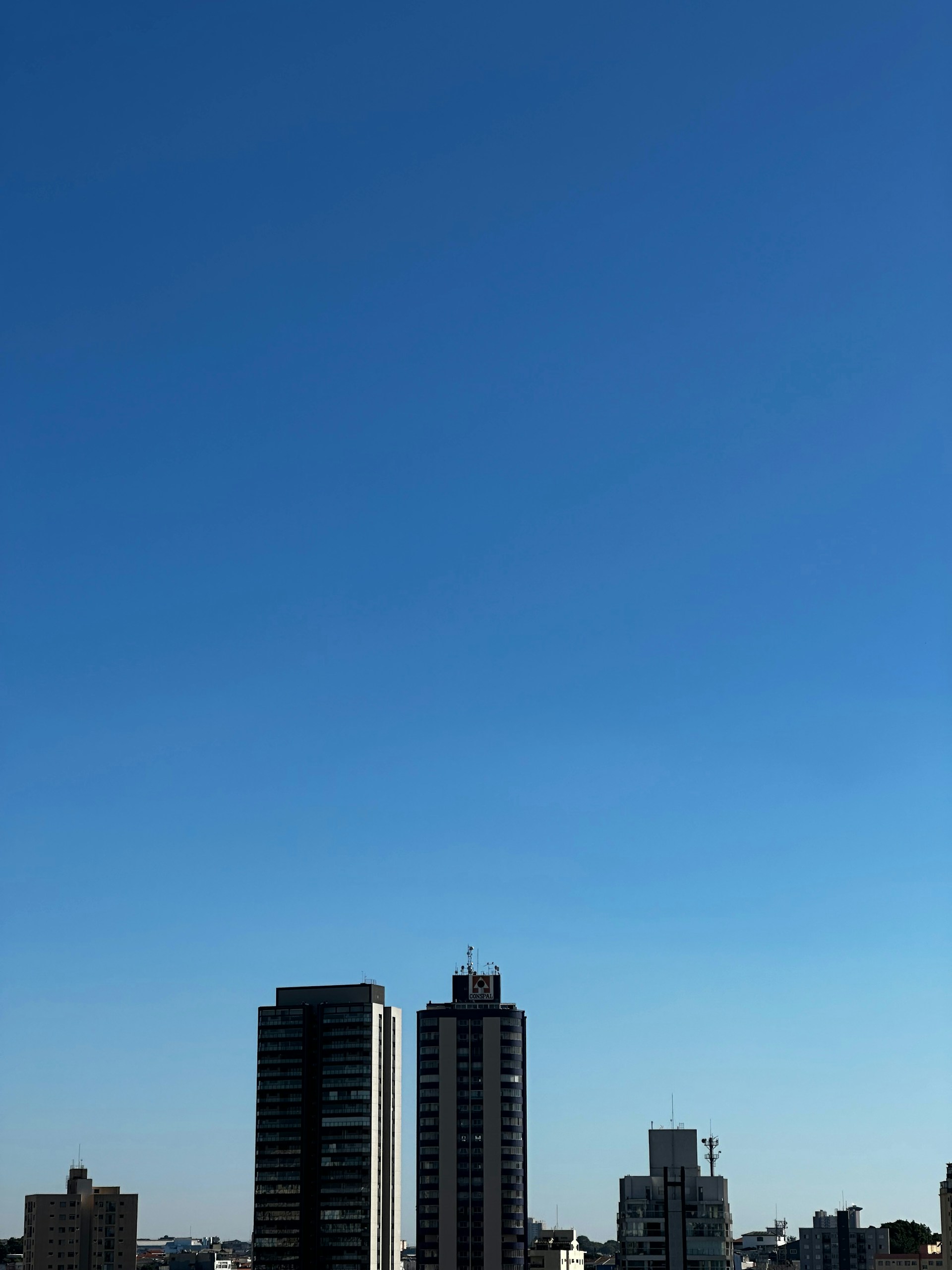 a plane flying over a city with tall buildings