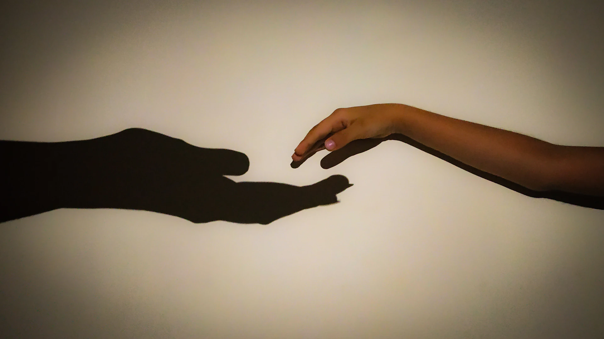 two hands reaching out towards each other