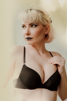 a woman in a black bra posing for a picture