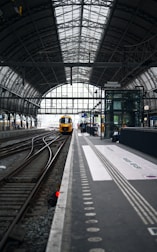 a train station with a train on the tracks