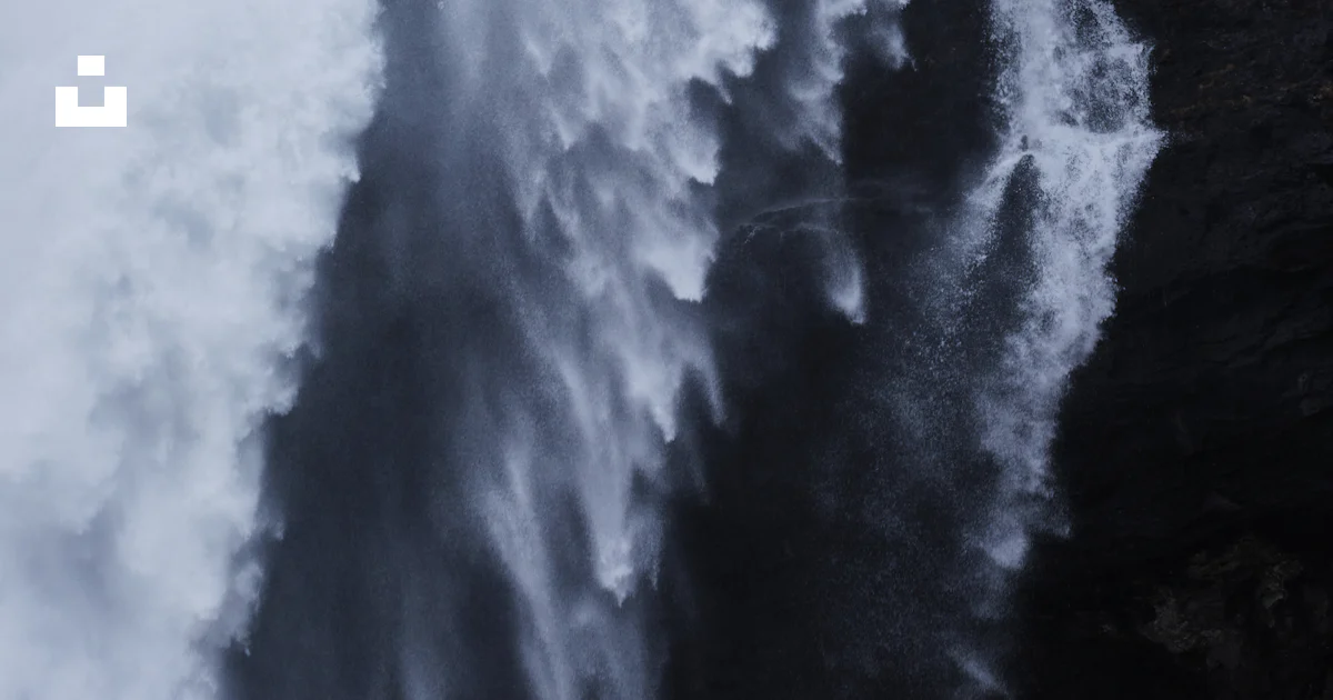 A large waterfall with a large amount of water coming out of it photo ...