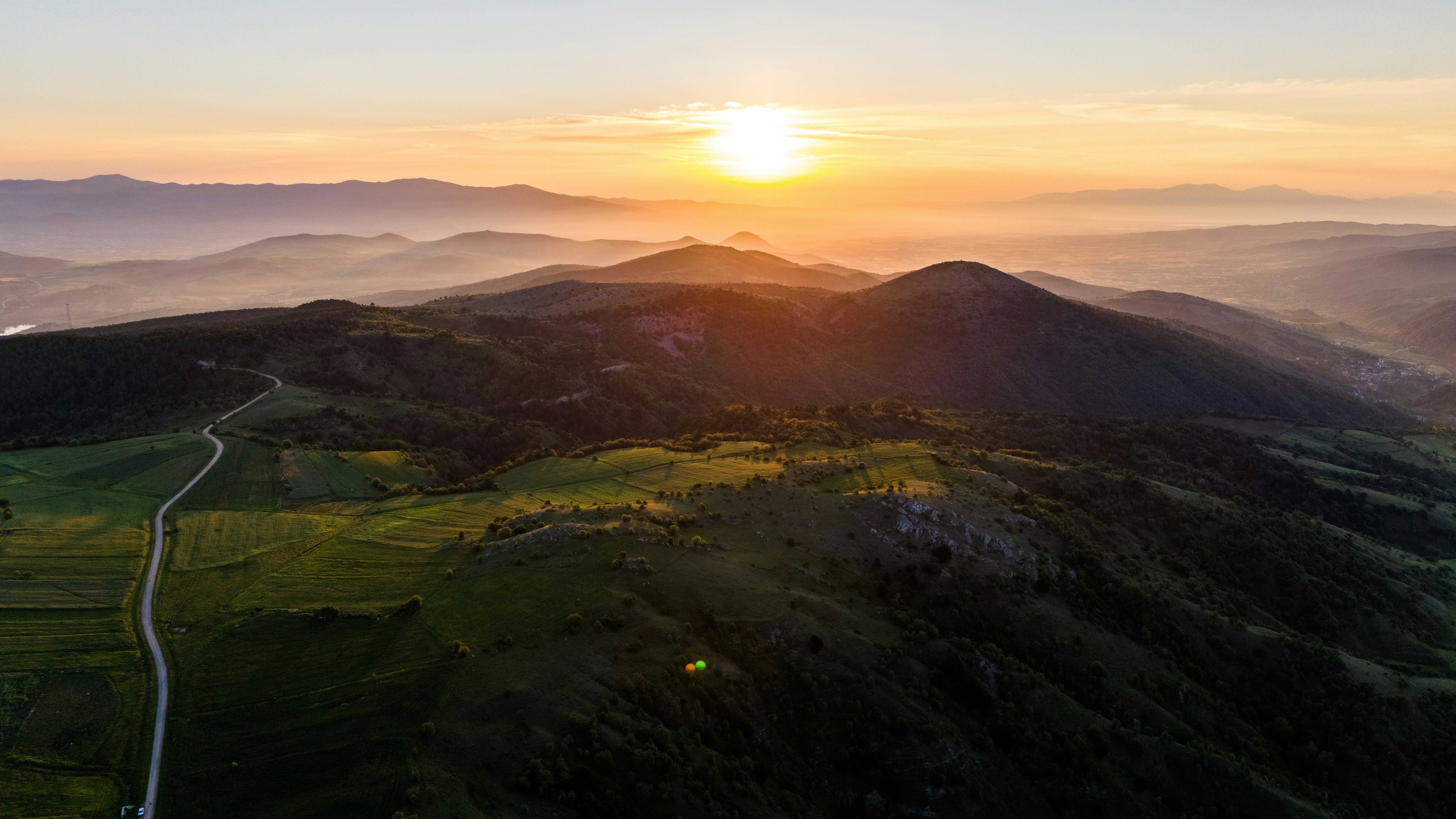 The sun is setting over a mountain range photo – Free Sunrise Image on ...