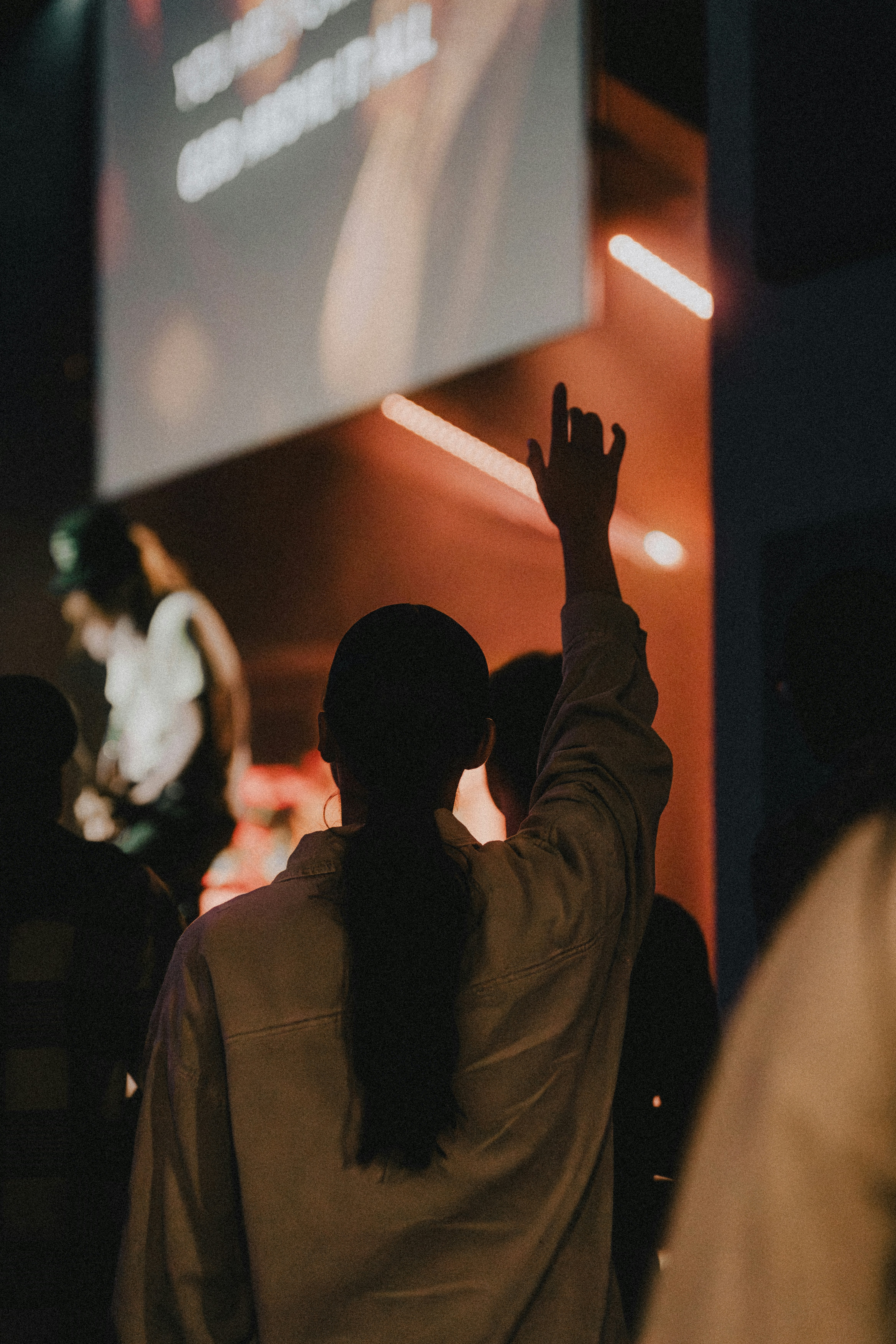 a woman standing in front of a projection screen