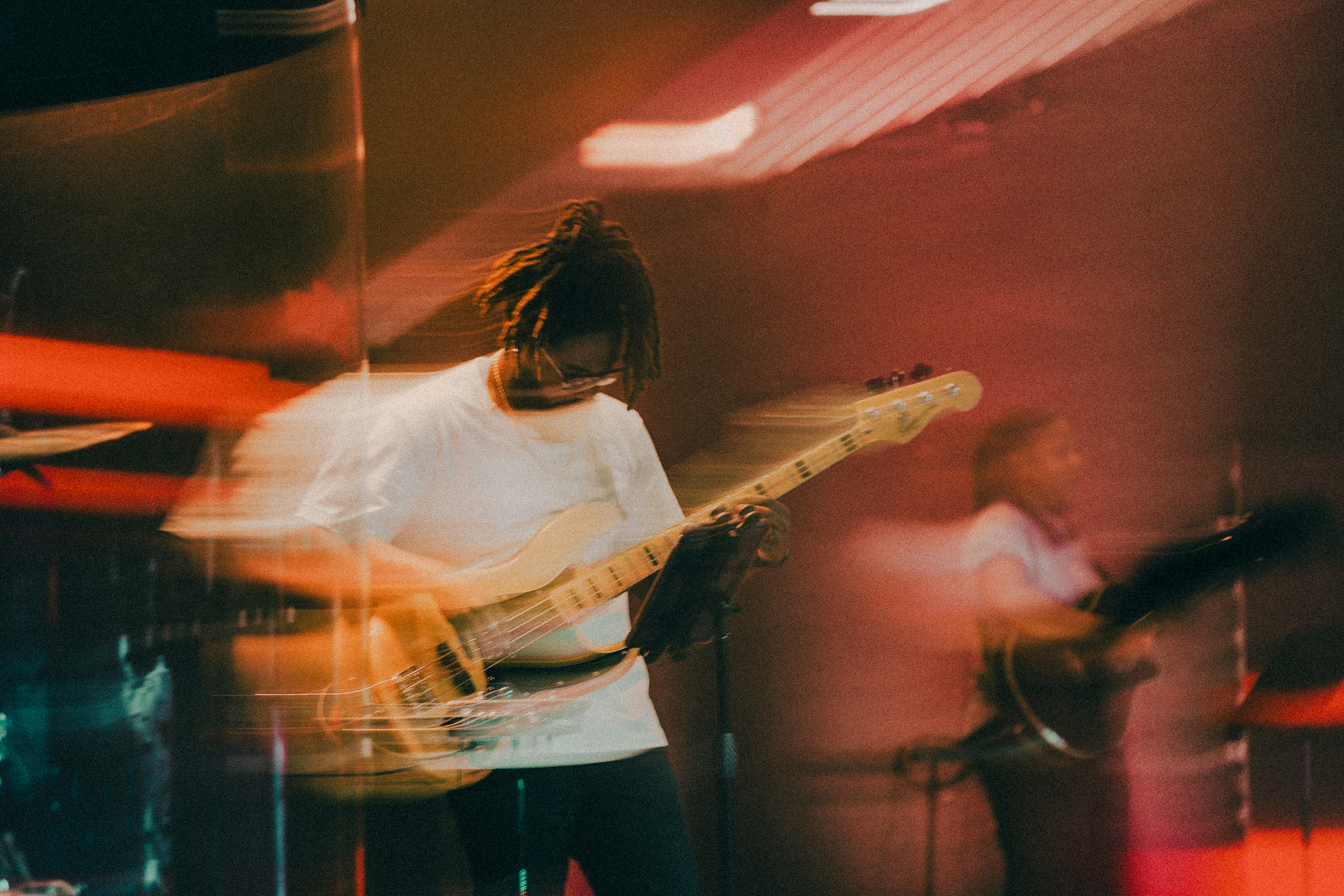 a man with dreadlocks playing a guitar