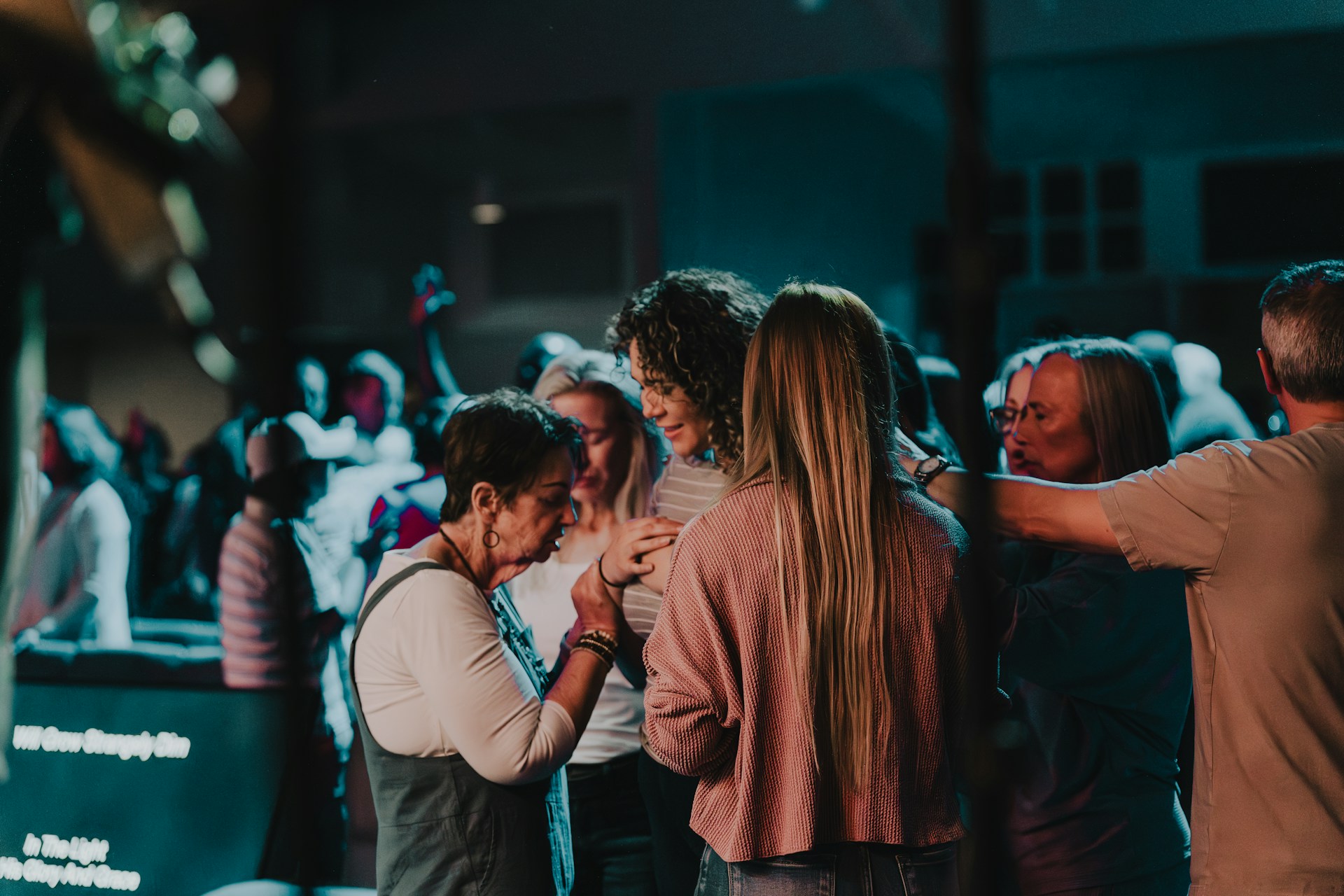 a group of people standing around each other