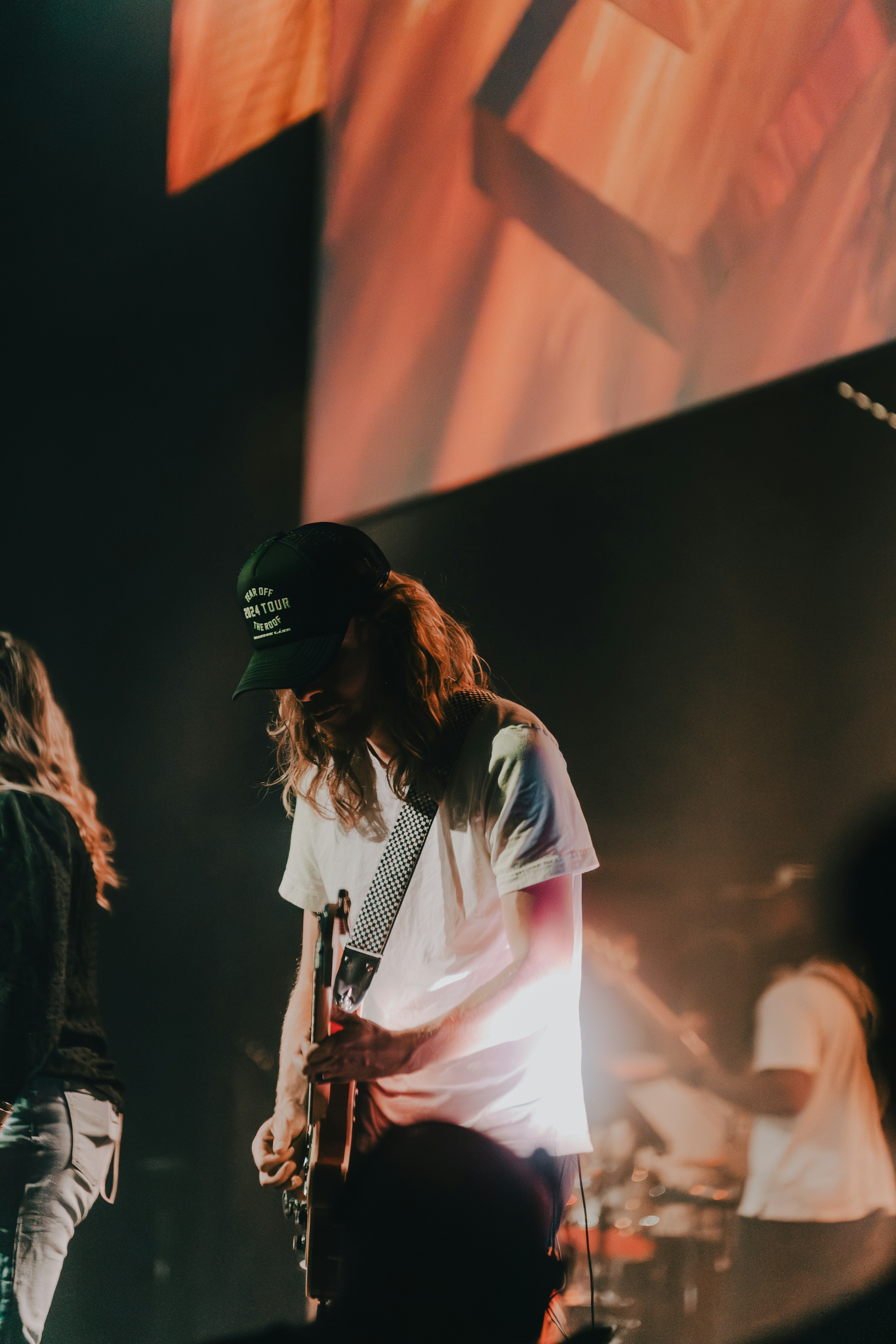 a man standing on a stage with a guitar