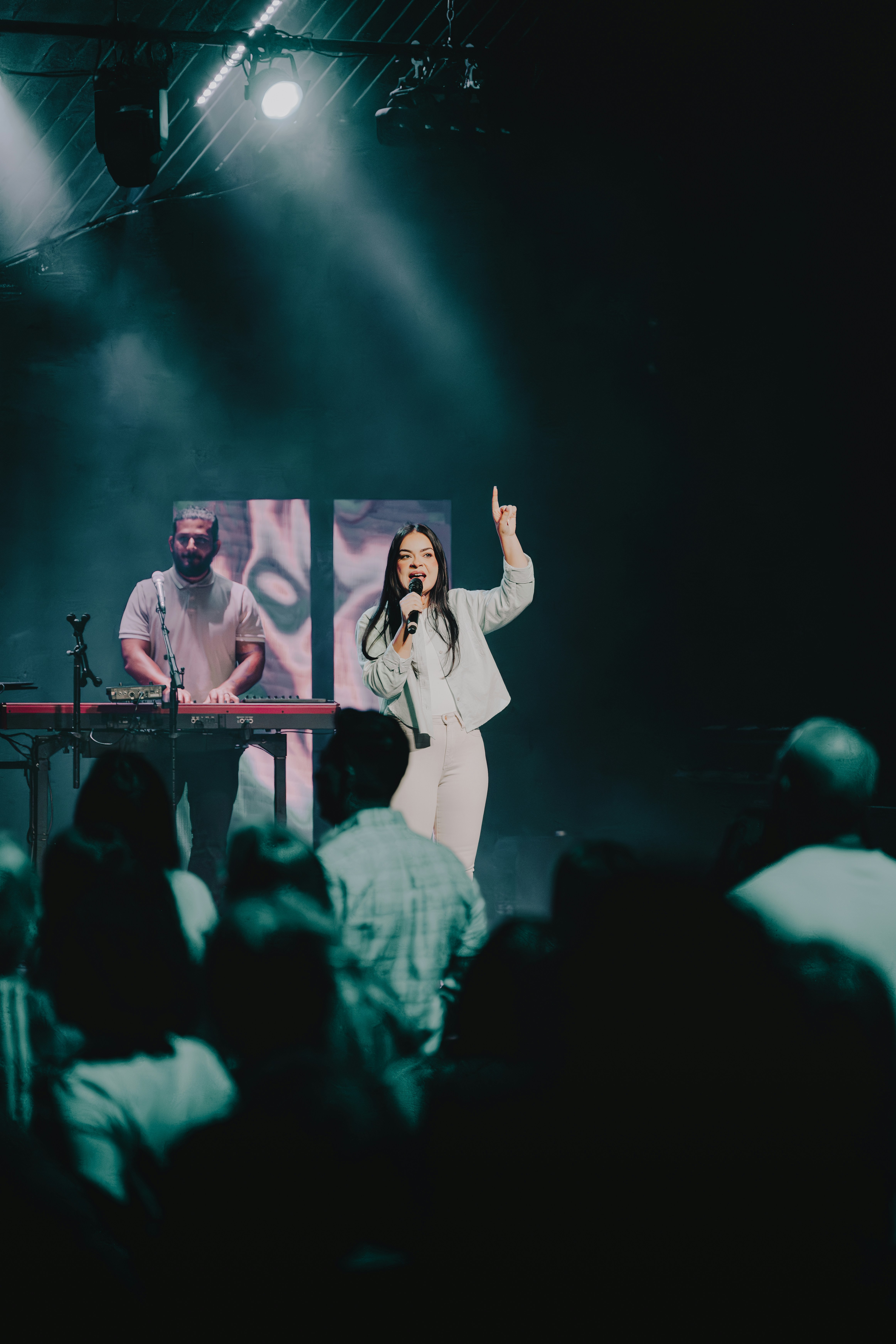 a woman standing on a stage in front of a crowd
