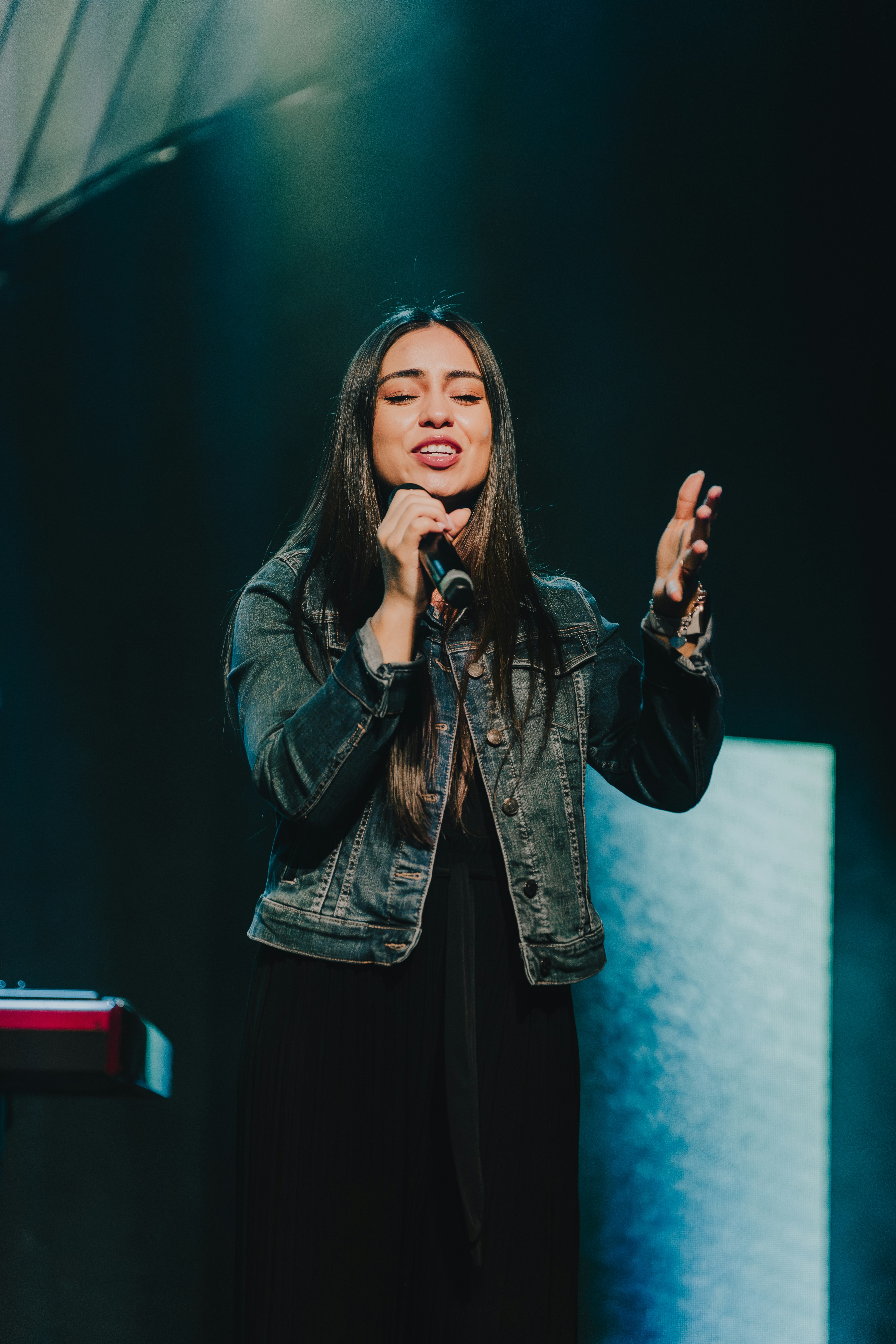 a woman standing in front of a microphone
