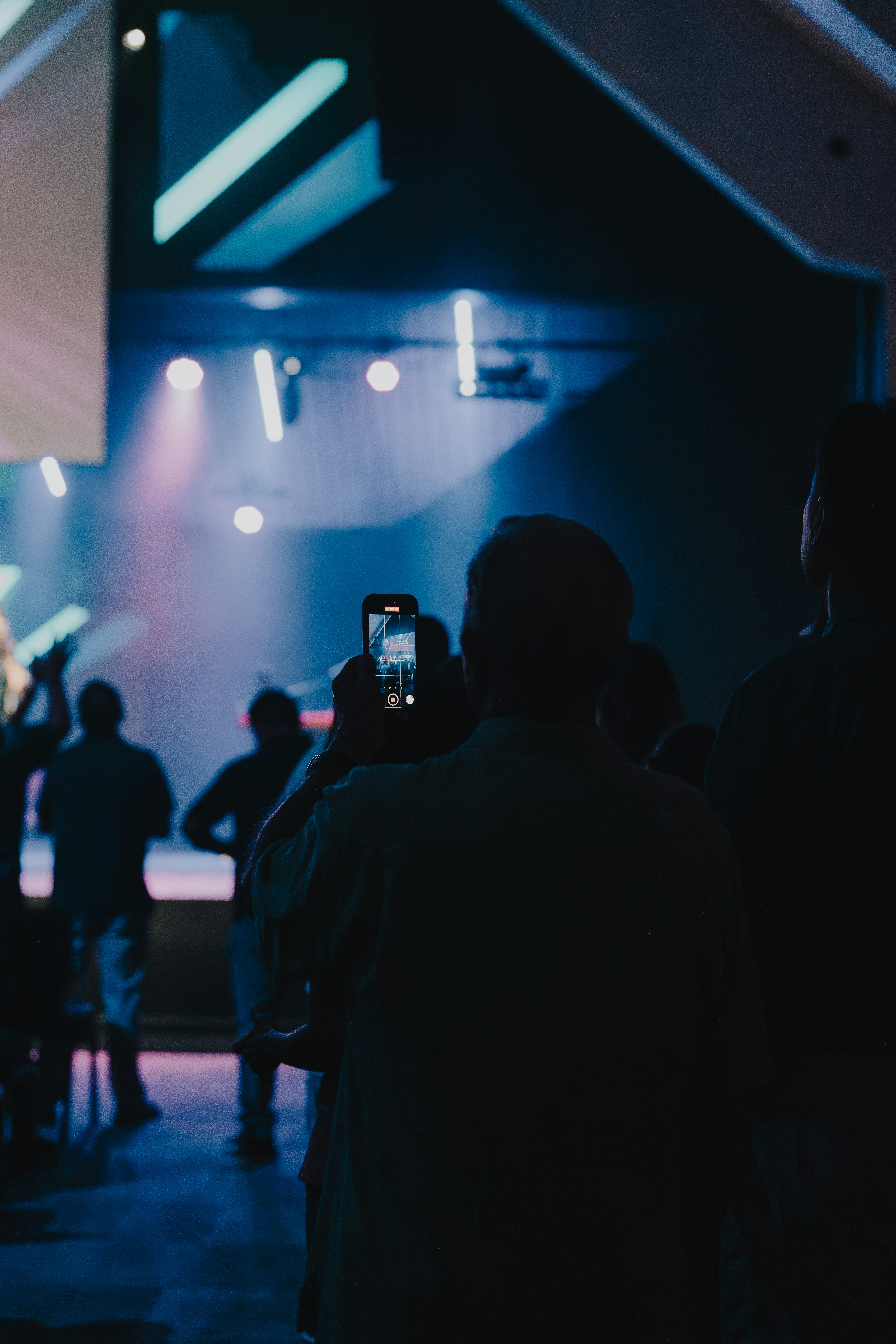 a group of people standing in front of a stage