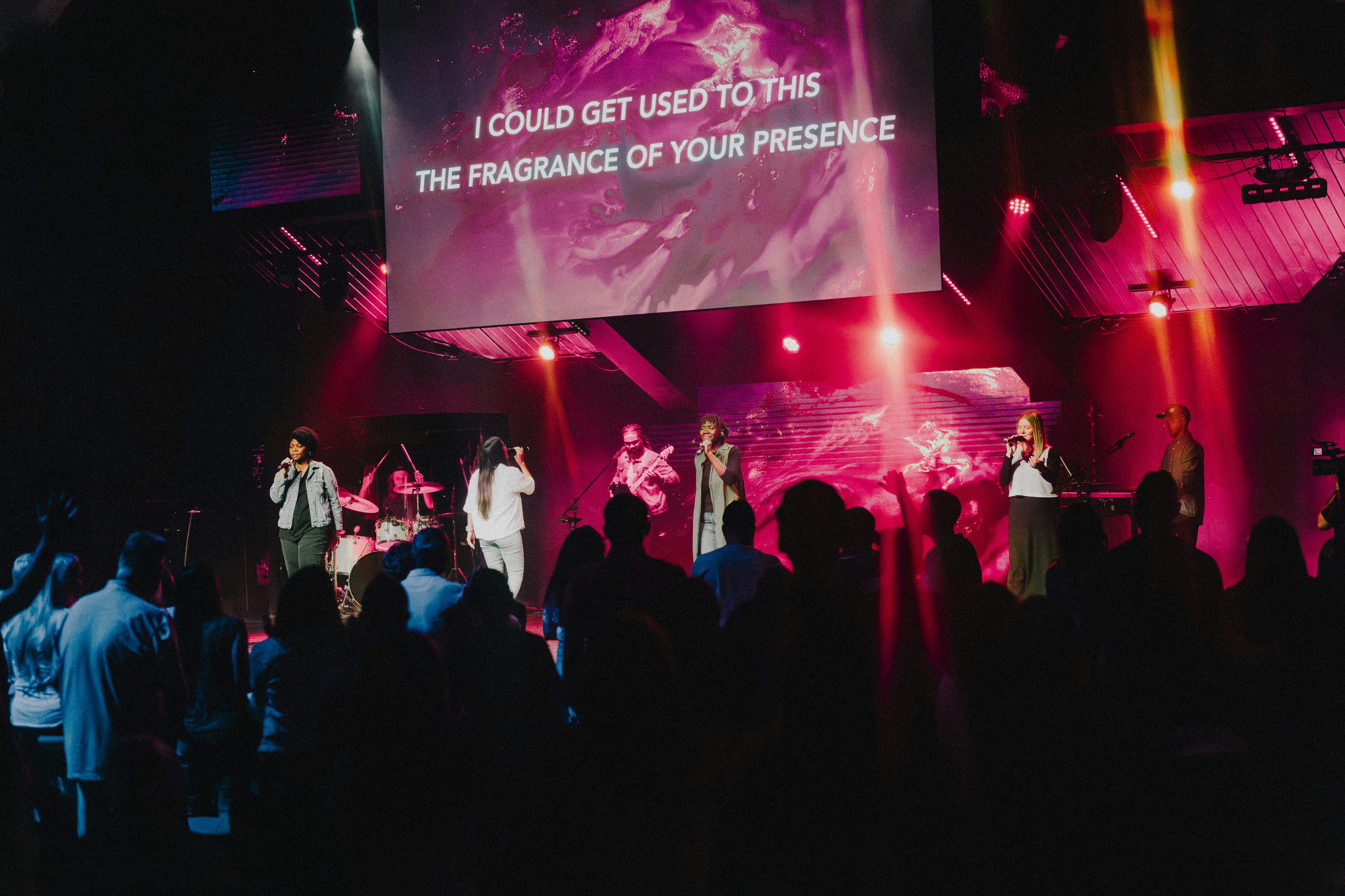 a group of people standing on top of a stage