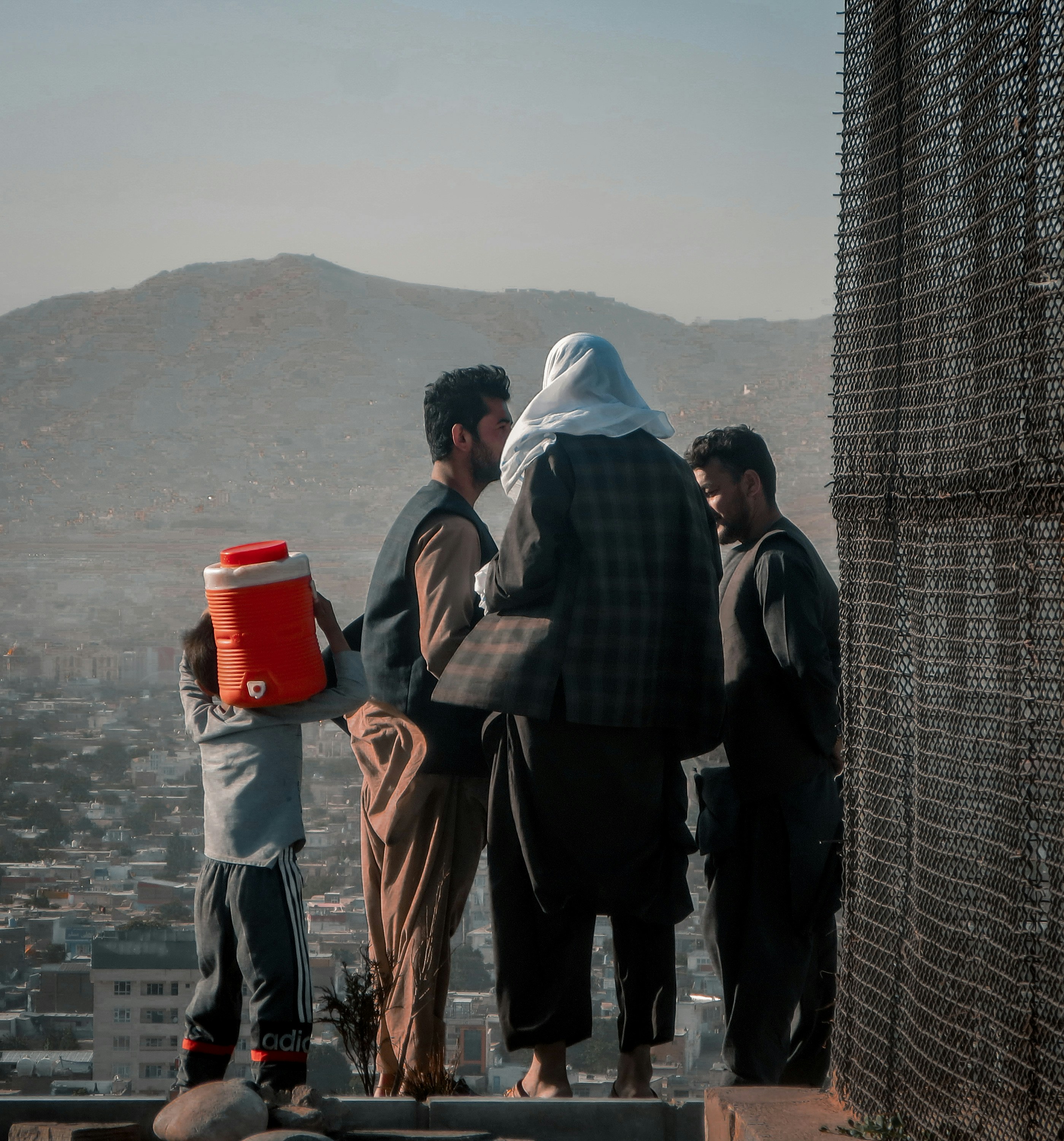 a group of people standing on top of a building