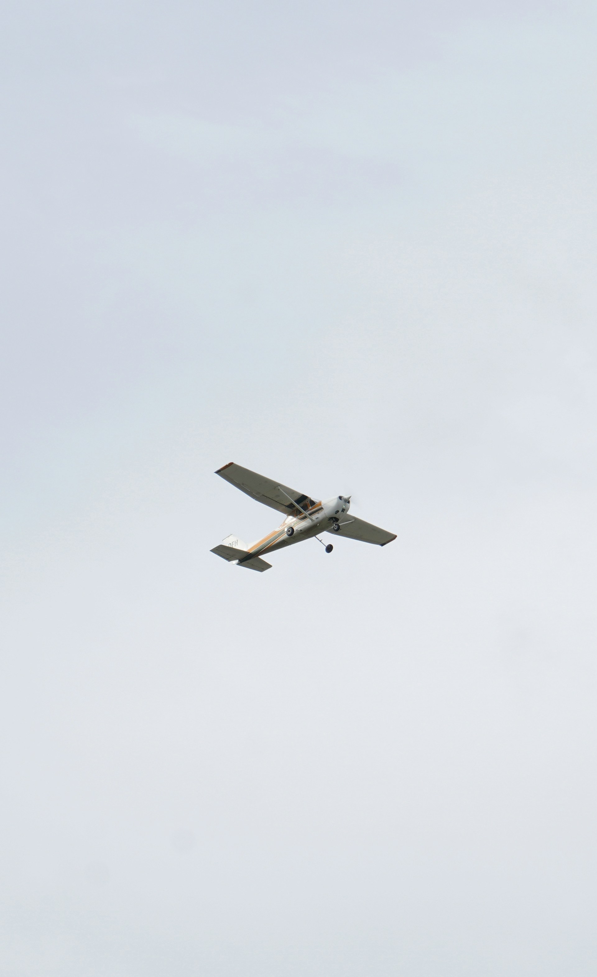 a small airplane flying through a cloudy sky