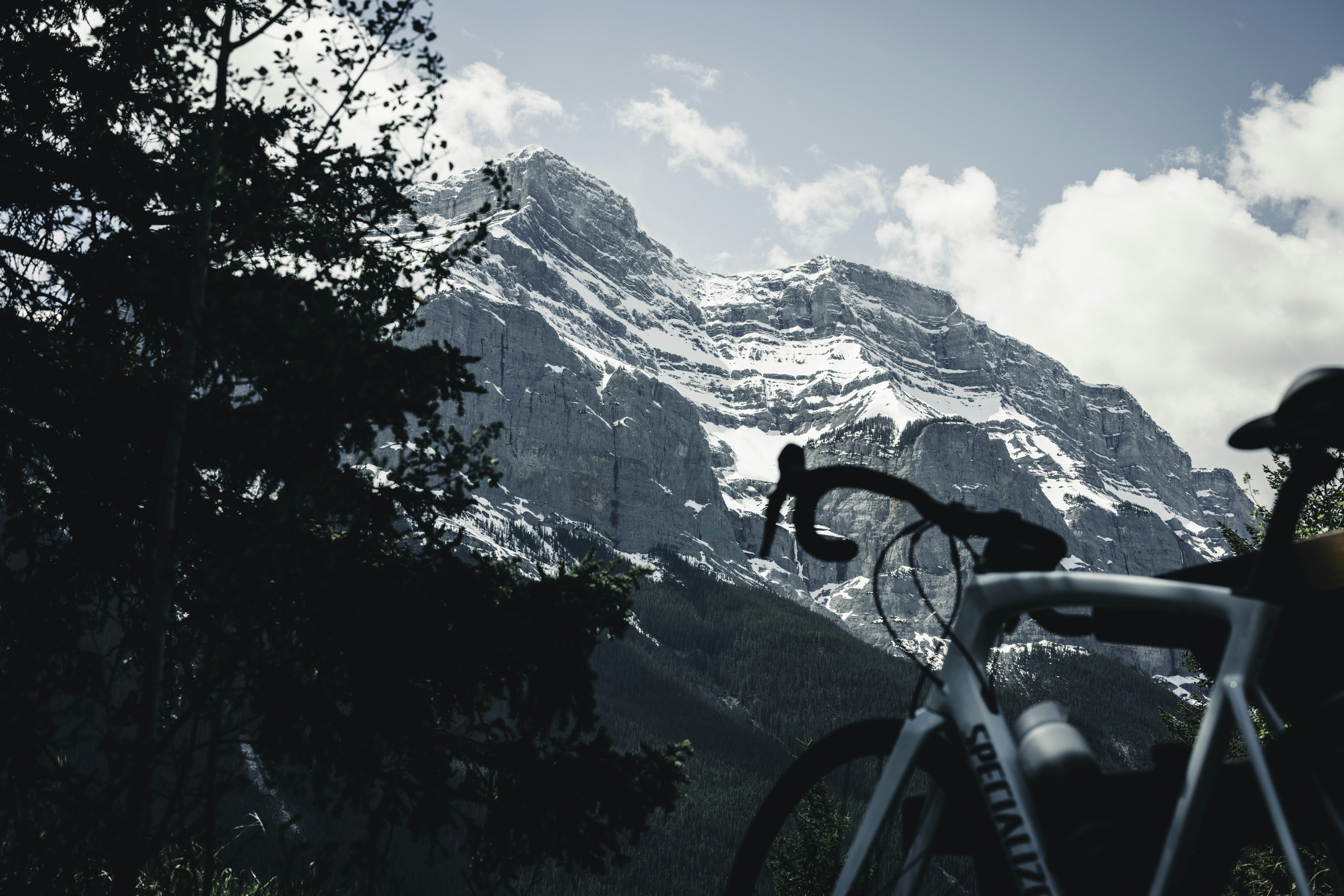 a mountain view with a bicycle parked in the foreground