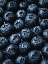 a pile of blueberries sitting on top of a table