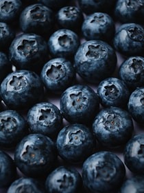 a pile of blueberries sitting on top of a table