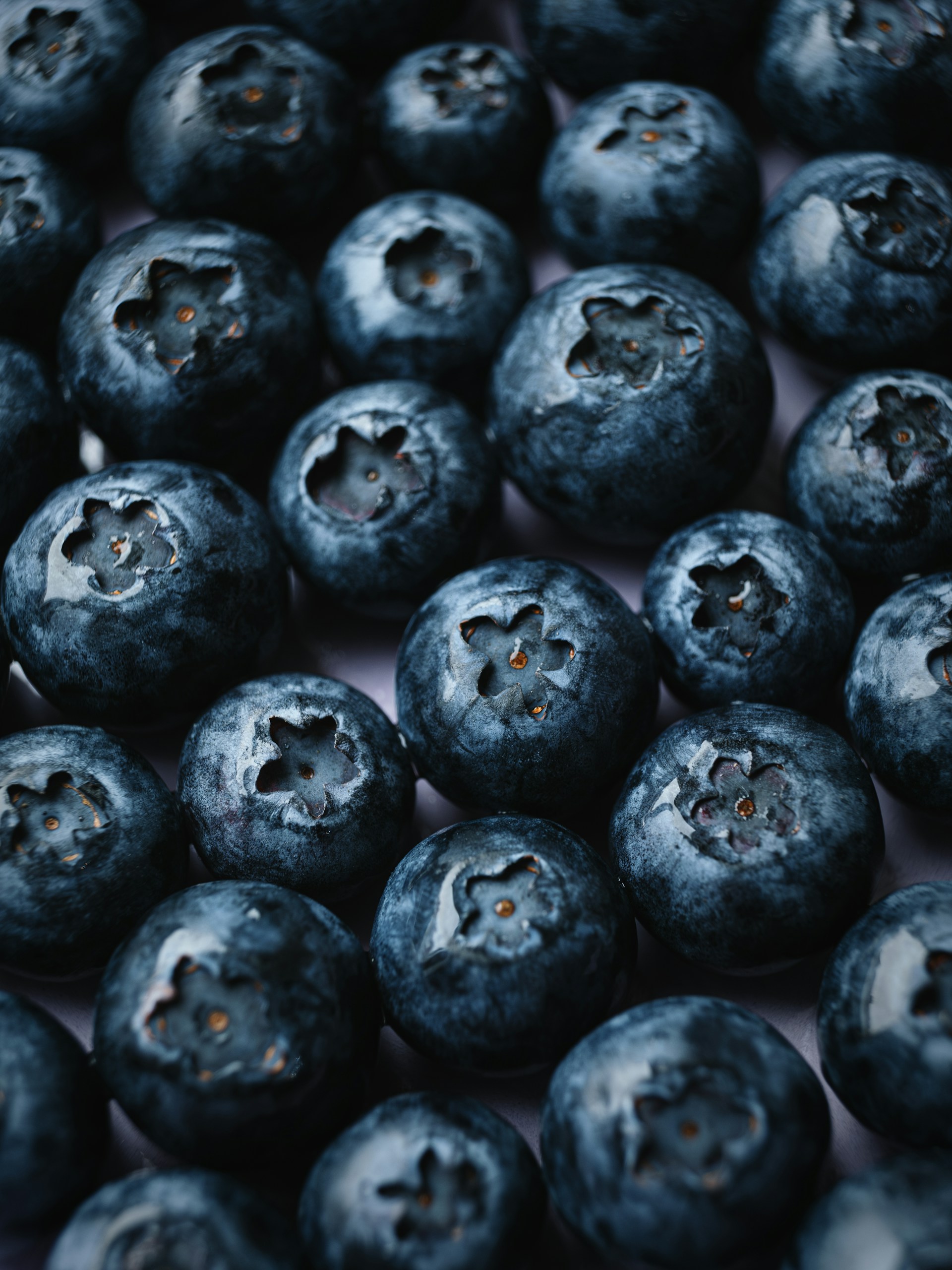 a pile of blueberries sitting on top of a table
