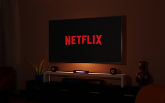 a flat screen tv sitting on top of a entertainment center