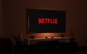 a flat screen tv sitting on top of a entertainment center