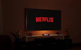 a flat screen tv sitting on top of a entertainment center