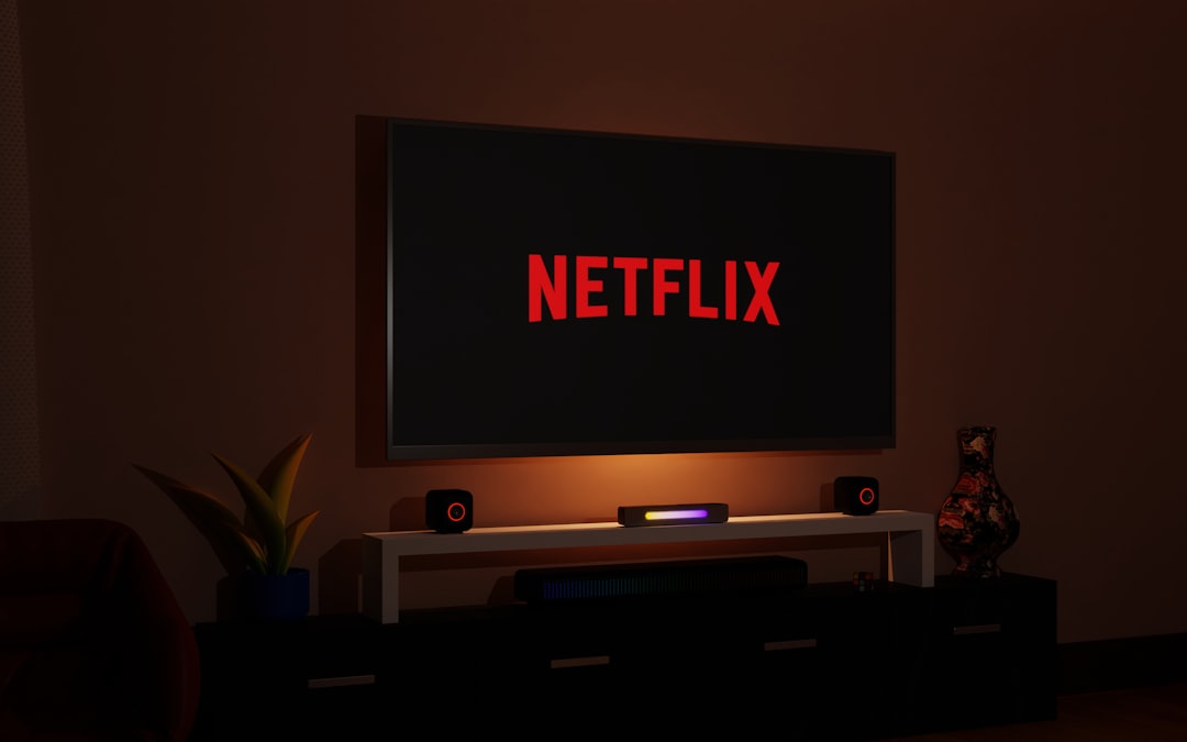 a flat screen tv sitting on top of a entertainment center, television, Netflix, Netflix logo, room, living room, entertainment, screen, technology, home, decoration, design, interior, space, relaxation, leisure, rest, streaming, streaming services, TV, flat screen, electronics, electronic devices, gadgets, tech gadgets, electronic gadgets, entertainment gadgets, home gadgets, tech gadgets, streaming gadgets, Netflix gadgets.