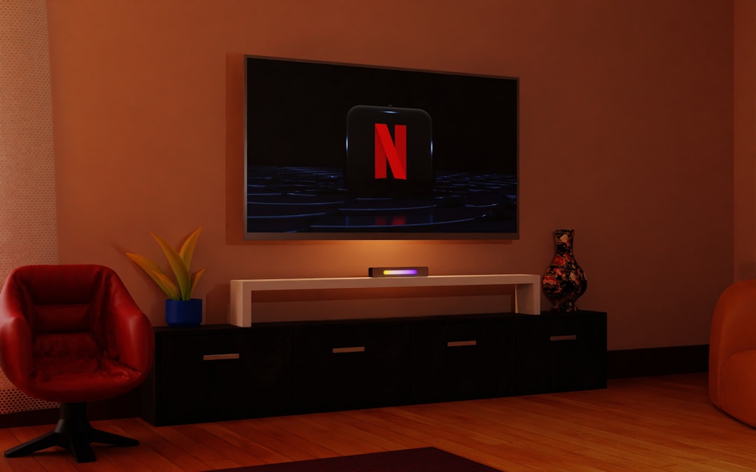 a living room with a flat screen tv on the wall, television, Netflix, Netflix logo, room, living room, entertainment, screen, technology, home, decoration, design, interior, space, relaxation, leisure, rest, streaming, streaming services, TV, flat screen, electronics, electronic devices, gadgets, tech gadgets, electronic gadgets, entertainment gadgets, home gadgets, tech gadgets, streaming gadgets, Netflix gadgets.