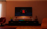 a flat screen tv sitting on top of a tv stand