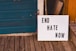 a sign that says end hate now on a porch