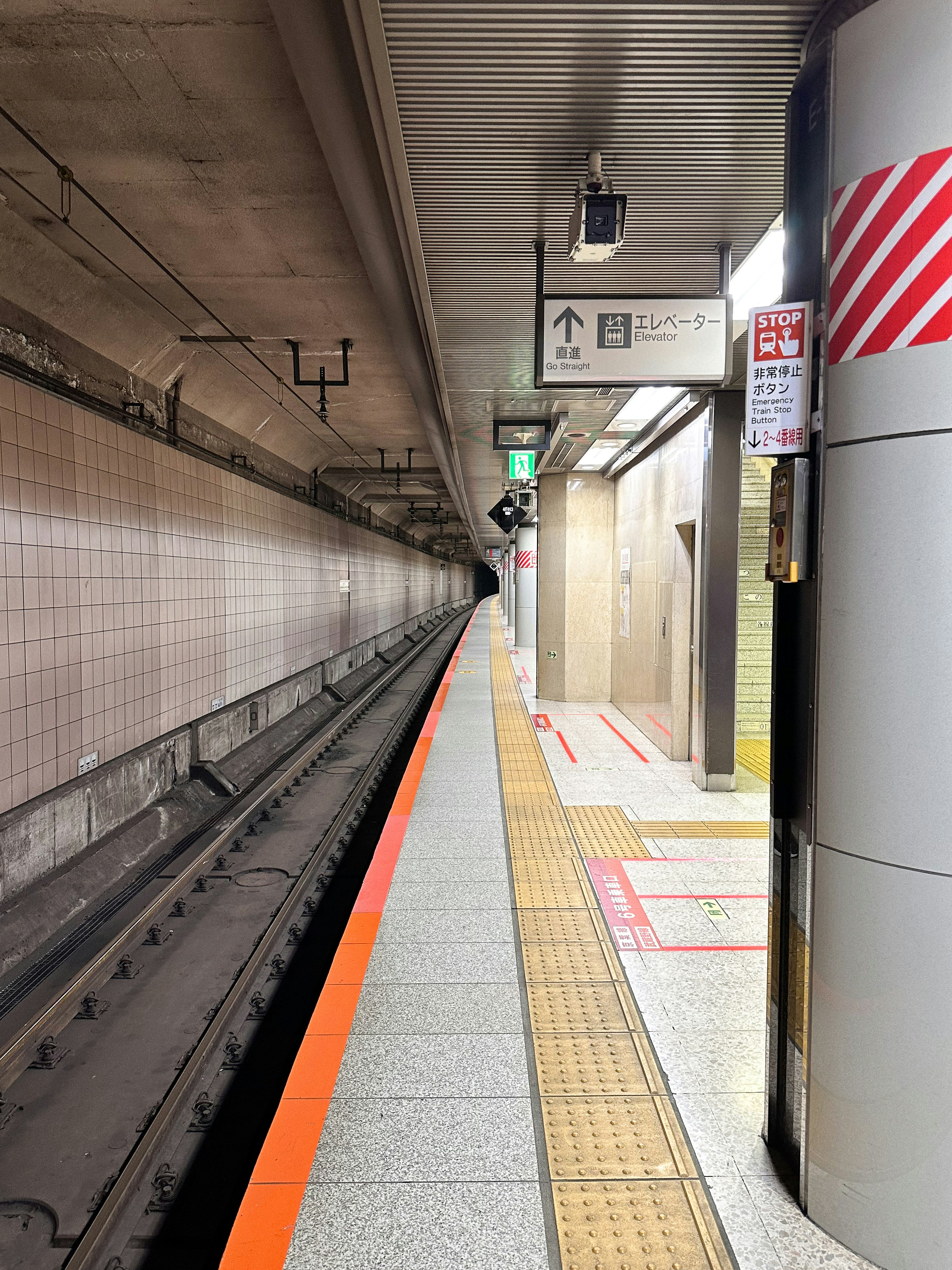 a subway station with a train on the tracks