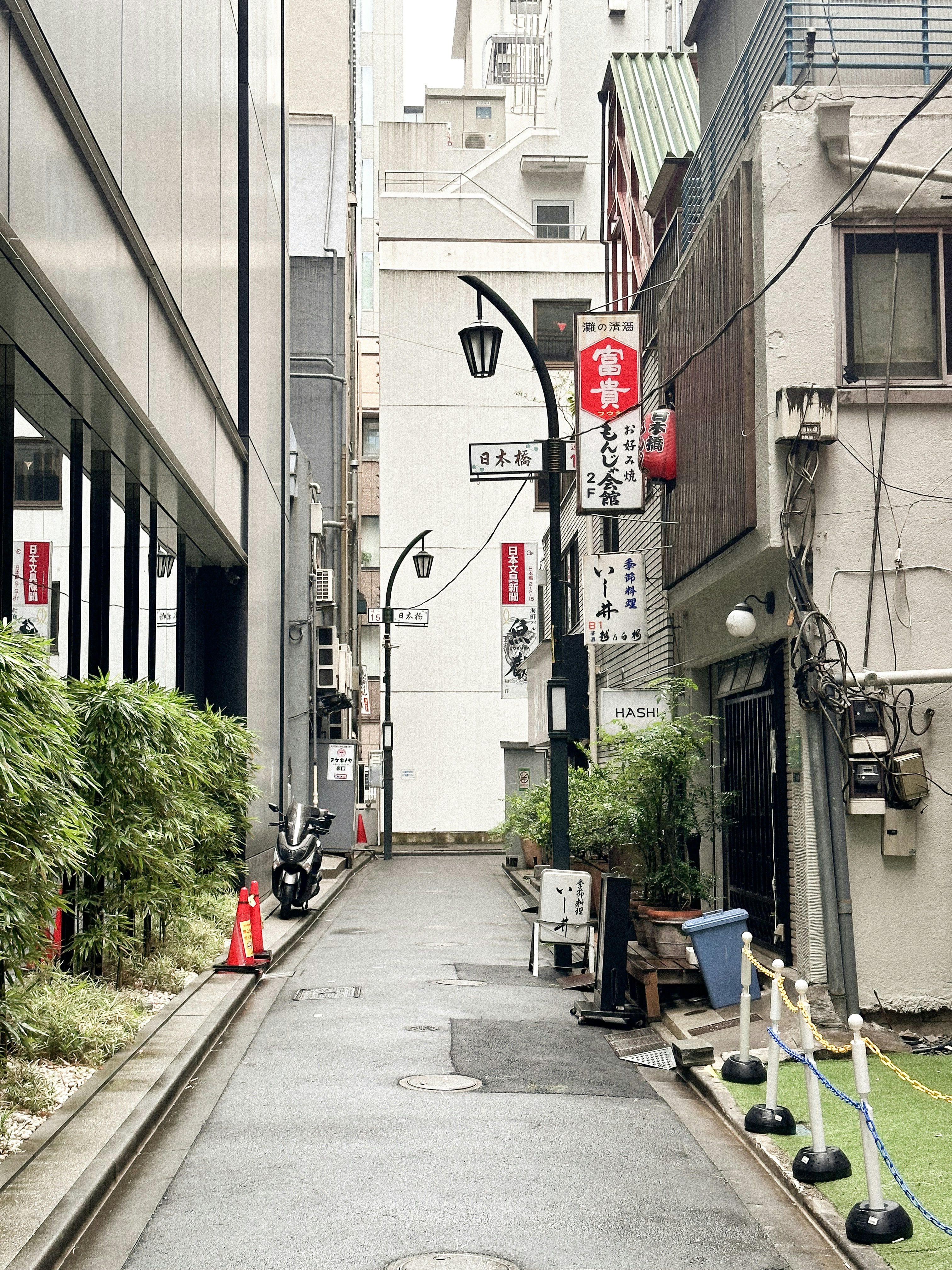 a narrow city street lined with tall buildings