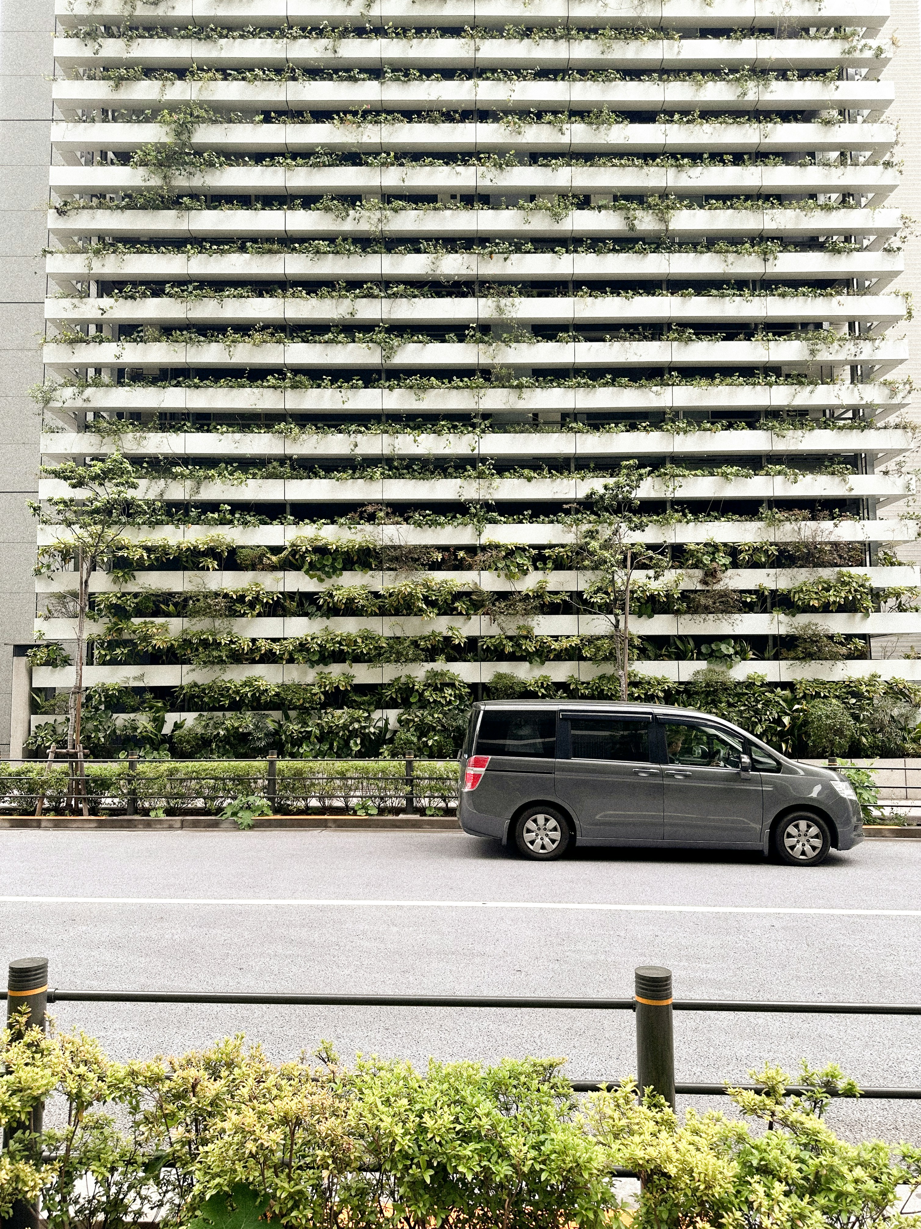 a black van parked in front of a tall building