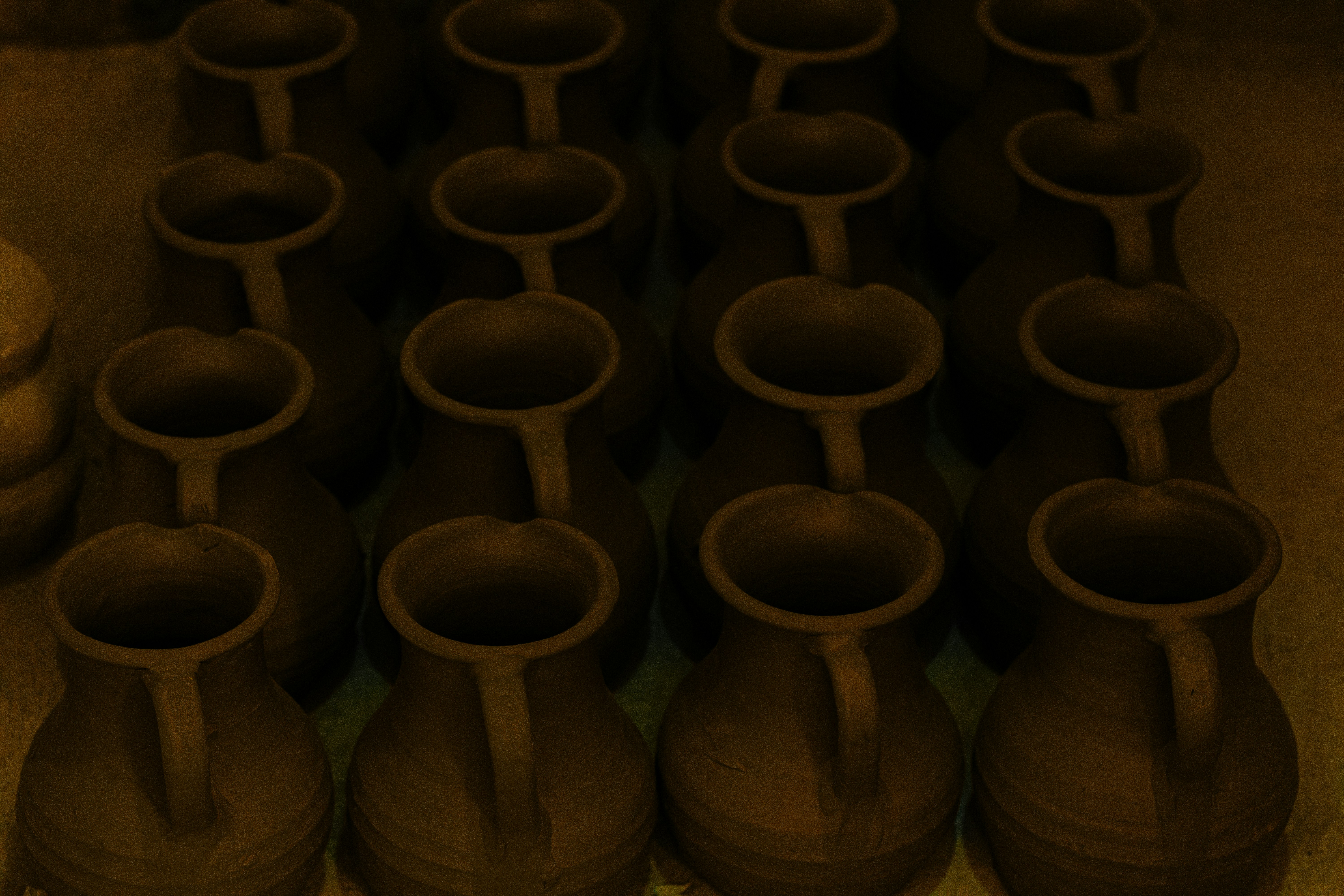 a group of brown vases sitting next to each other