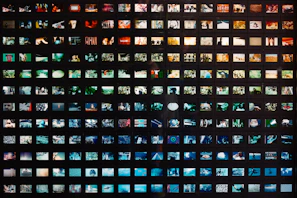 a black wall with a lot of different pictures on it