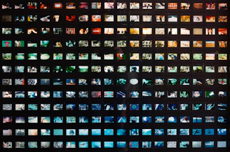 a black wall with a lot of different pictures on it