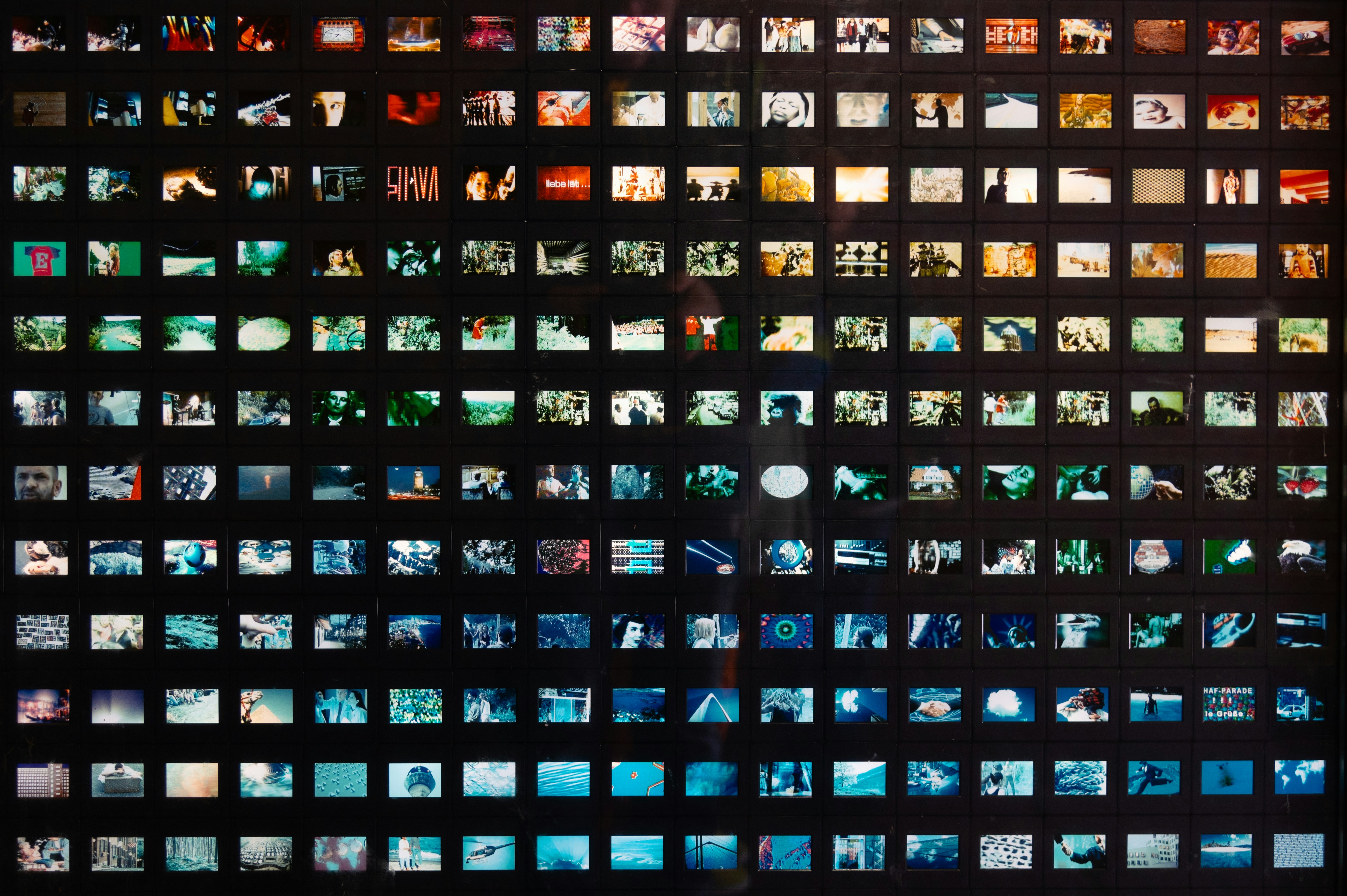 a black wall with a lot of different pictures on it